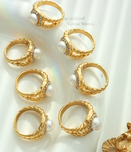 Detail of gold woven rings set with freshwater pearls and sparkling zircon accents