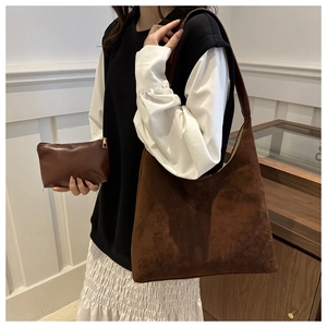 Detail of coffee suede hobo shoulder bag set with a dark brown leather zip pouch