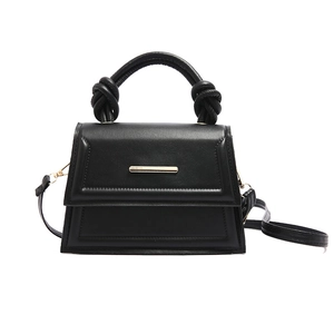 Minimalist black trapezoid handbag with knotted handle and golden metal accent