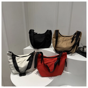 Close-up of durable nylon crescent bags in four colors with adjustable wide straps
