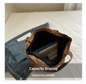 Interior detail of large brown tote bag showing zipper closure and spacious capacity