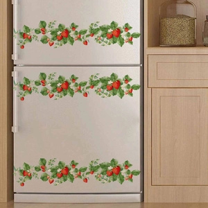 Pastel strawberry floral vine wall stickers on a white refrigerator in a warm kitchen decor
