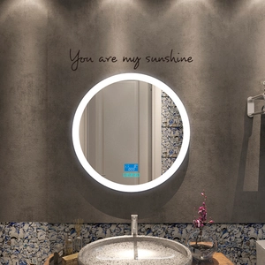 Close-up of smart round LED bathroom mirror with digital time and temperature display
