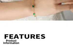 Close-up of gold chain bracelet with emerald green zircon stones and adjustable link