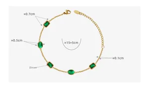 Detail of gold plated titanium steel bracelet with green zircon inlay and lobster clasp