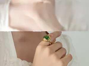 Detail view of a vintage gold titanium ring with a large square green zircon gemstone