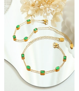 Close-up of 18K gold-plated double-strand bracelet with emerald green zircon gemstones