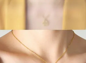 Close-up of golden stainless steel cross chain necklace worn on the neck
