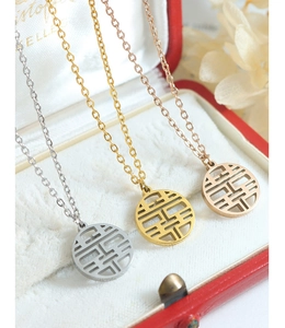 Detailed view of Chinese Double Happiness pendants in silver, gold and rose gold finishes