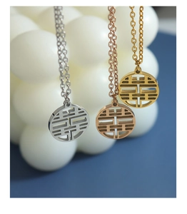 Detailed view of Chinese Double Happiness necklaces in gold, silver, and rose gold finishes