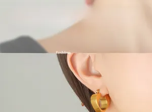 Model wearing gold-plated heart hoop earrings in a minimalist and vintage style