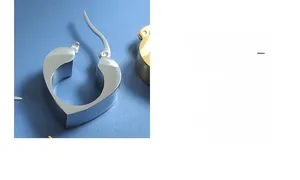 Detailed macro view of silver heart-shaped earrings with high-polish metallic finish