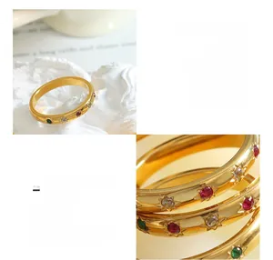 Detail of 18k gold plated titanium ring with star-set red green white zircon stones