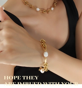 Detail of gold-plated twisted chain necklace and bracelet set with freshwater pearls
