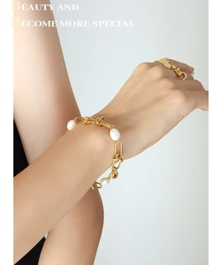 Detailed shot of a gold-plated twist chain bracelet featuring elegant freshwater pearls