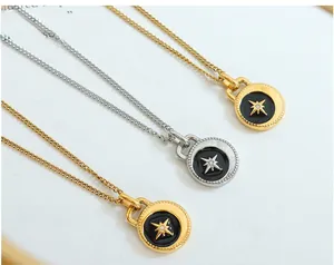 Detailed shot of celestial star coin necklaces in gold and silver with black enamel