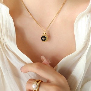 Elegant gold necklace with star pendant and pearl ring on minimalist white background