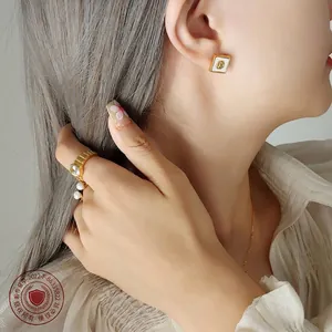 Set gioielli dorati con camelia, perle e zirconi indossati da una modella