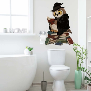 Detail of cartoon wizard owl reading books wall sticker on a white modern wall backdrop