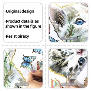 Macro shot of gold-stamped cat and butterfly window decals with double-sided visual detail