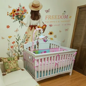 Cartoon baby bedding set with bumper and quilt on white crib against a floral wall