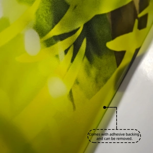 Detail of self-adhesive green leaf wall sticker showing easy-to-remove backing layer