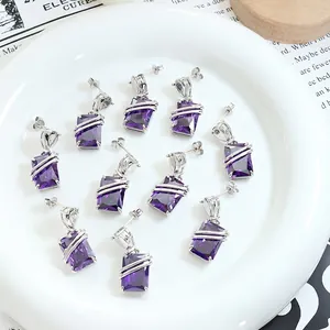 Exaggerated silver-wrapped purple rectangular zircon earrings on a white ceramic tray