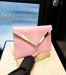 Close-up of pink envelope clutch featuring V-shaped stitching and gold metal buckle
