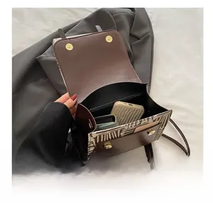 Detail view of large capacity interior with compartments for smartphone and wallet