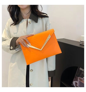 Fashionable bright orange envelope clutch bag with metal V-trim and elegant stitching