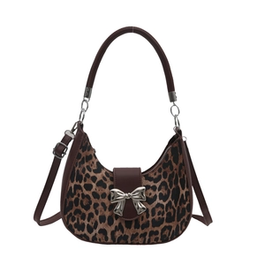 Leopard print hobo bag with brown leather trim and silver bow detail on white background