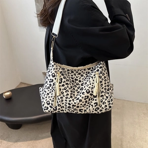 Chic leopard print oversized tote bag with side zippers and white wide shoulder strap