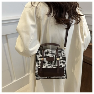 British style crossbody bag featuring black white abstract texture and brown leather trim
