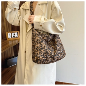 Detail of trendy leopard print canvas tote bag featuring spacious design and wide strap