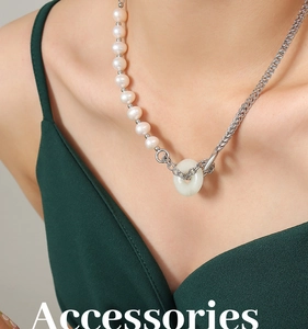 Détail d'un collier en perles d'eau douce avec pendentif en jade et chaîne en acier