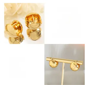 Detailed view of glossy gold-plated copper ball hoop earrings on a display stand