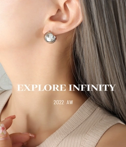 Close-up of minimalist silver polished copper C-shape hoop earring worn by a model