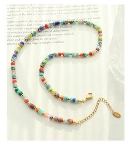 Detail of bohemian natural stone necklace with colorful beads and K18 gold clasp