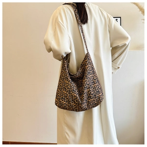 Detail view of the leopard print canvas hobo bag showing the texture and strap design