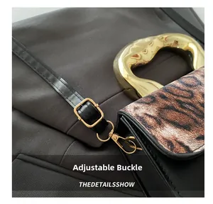 Close-up of adjustable strap buckle on vintage leopard print crossbody square bag