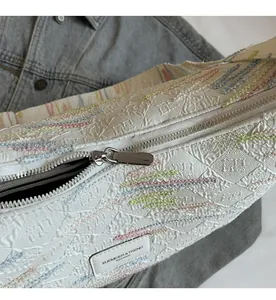 Detailed macro view of high-quality silver zipper and textured floral jacquard fabric