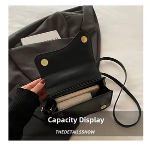Detail showing the internal storage capacity of the black saddle bag on a grey suit