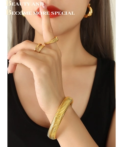 Detail of 18k gold plated stainless steel spiral textured cuff and matching ring set