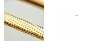 Macro detail of gold plated stainless steel elastic bracelet with modular link structure