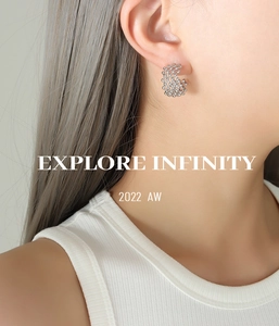 Close-up of silver hollow mesh C-shaped hoop earrings worn on a model with minimal aesthetics