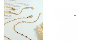 Detailed shot of gold-plated titanium necklaces with colorful enamel and shell accents