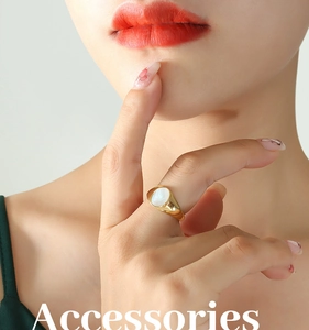 Close-up of a minimalist gold stainless steel ring with an oval white shell inlay
