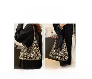 Detail view of large leopard print canvas tote bag showing shoulder and hand-carry styles