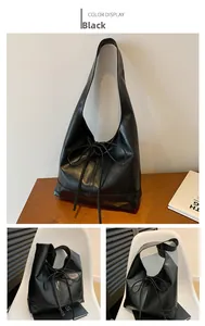 Detail of black pleated hobo bag featuring glossy synthetic leather and rope tie decor