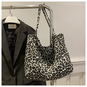Detail of leopard print corduroy tote bag hanging on a rack for daily use